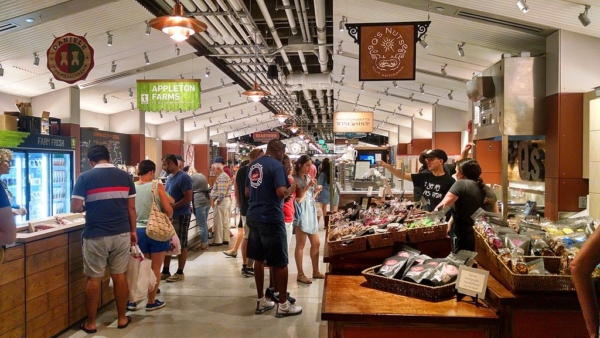 aisle in an open food market with people