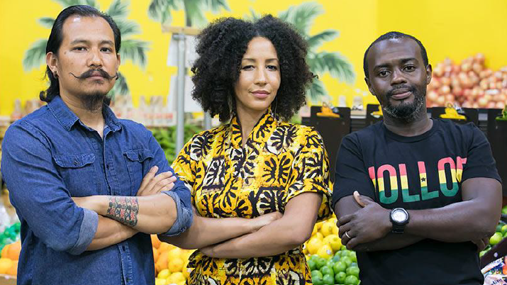 Man with moustache, woman with black hair, Black man all look out with arms crossed